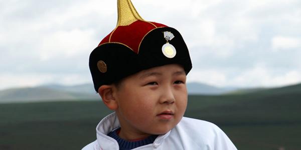 Mongolian boy gazing into the mountains