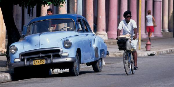 A bike and an old-fashioned American car, the traditional modes of transport in Cuba