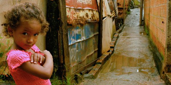 Girl outside a favela in Brazil.