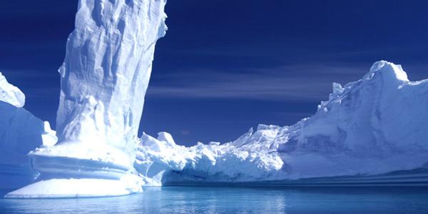 A large iceberg amidst the bright blue scenery of Antarctica