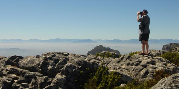 Man with binoculars looking for Capetown.