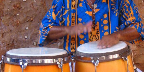 Close up of a Cuban man playing the drums.