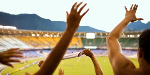 Close up of fans cheering for Brazil at a soccer match.