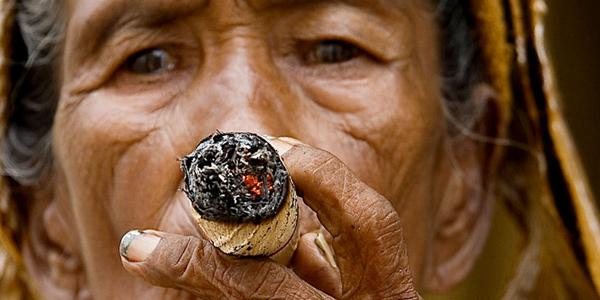 A woman smoking a Cuban cigar!