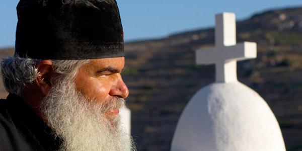 A priest in front of a church in Greece