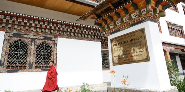 Bhutan Boy walking by a Textile Museum