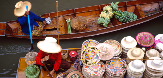 Locals river boating in Thailand