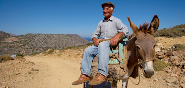 A Greek local riding his donkey