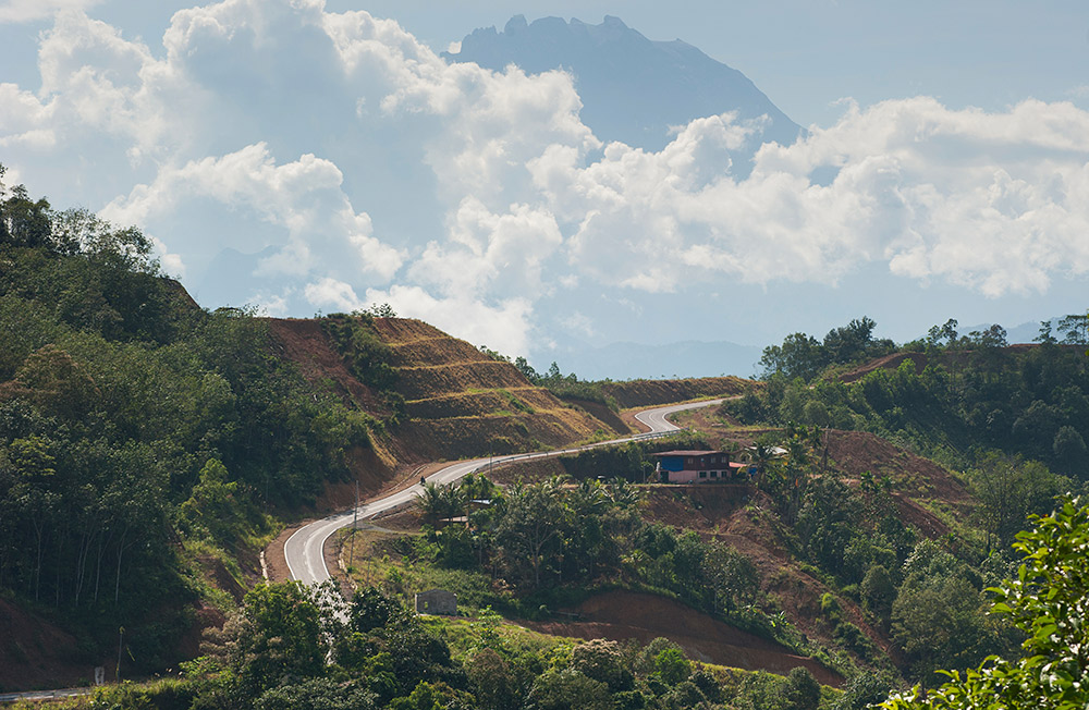 The peaks of Mt Kinabalu rise above the clouds.