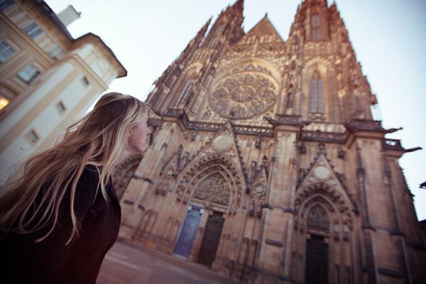 woman gazing up at a gothic cathedral