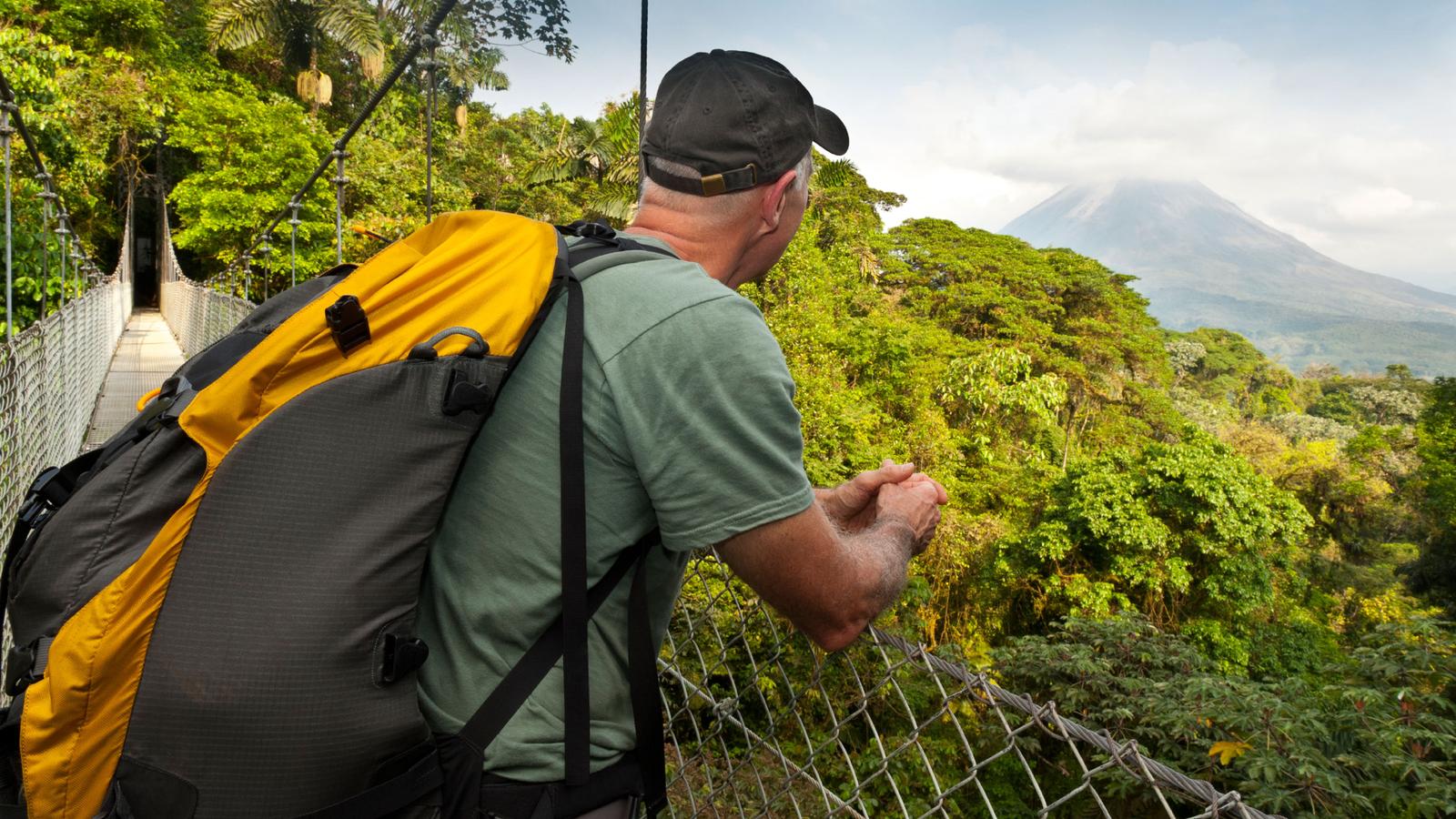 Male traveller looking over a bridge in Costa Rica