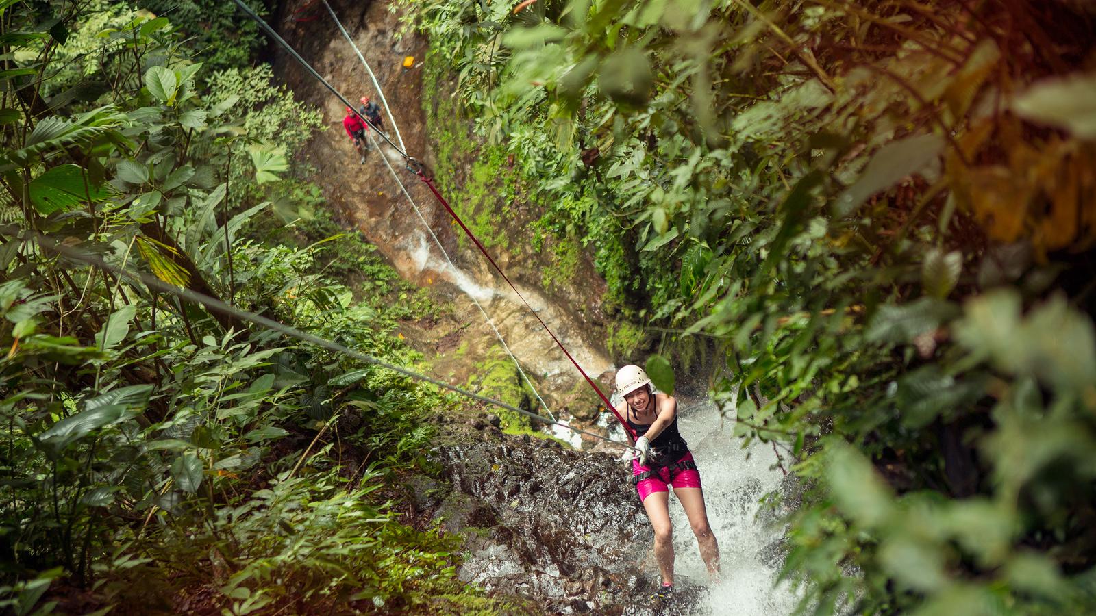 Female traveller climbing in the Costa Rican rainforest