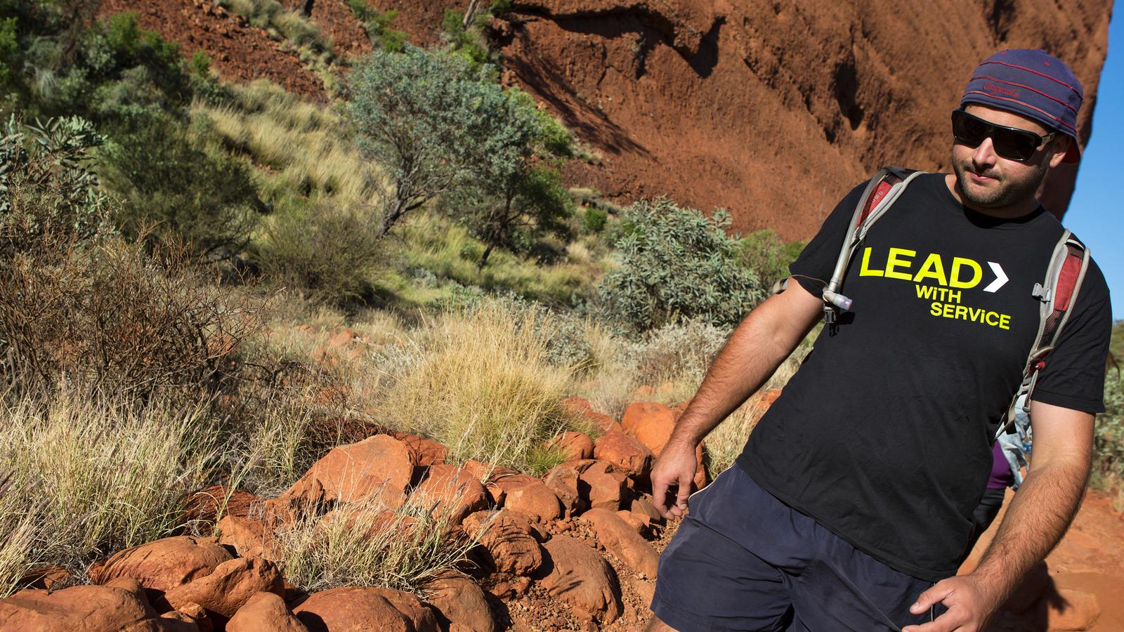 G Adventures CEO confidently walking down the rocky paths of Alice Springs in Australia