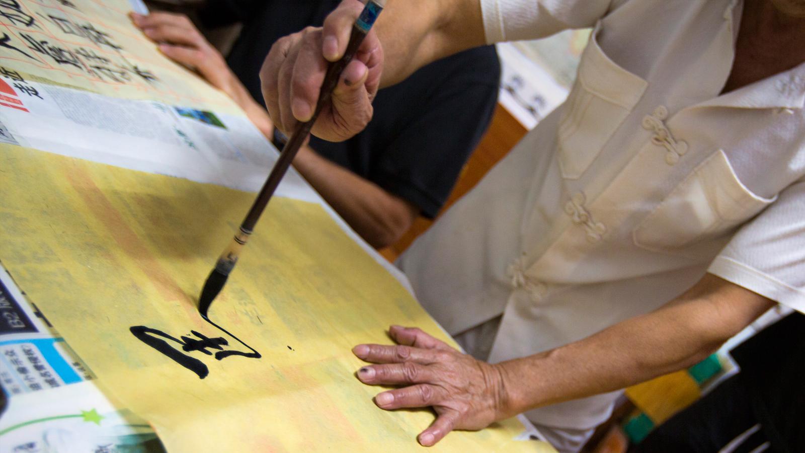 Family of travellers getting a calligraphy lesson in Xian China