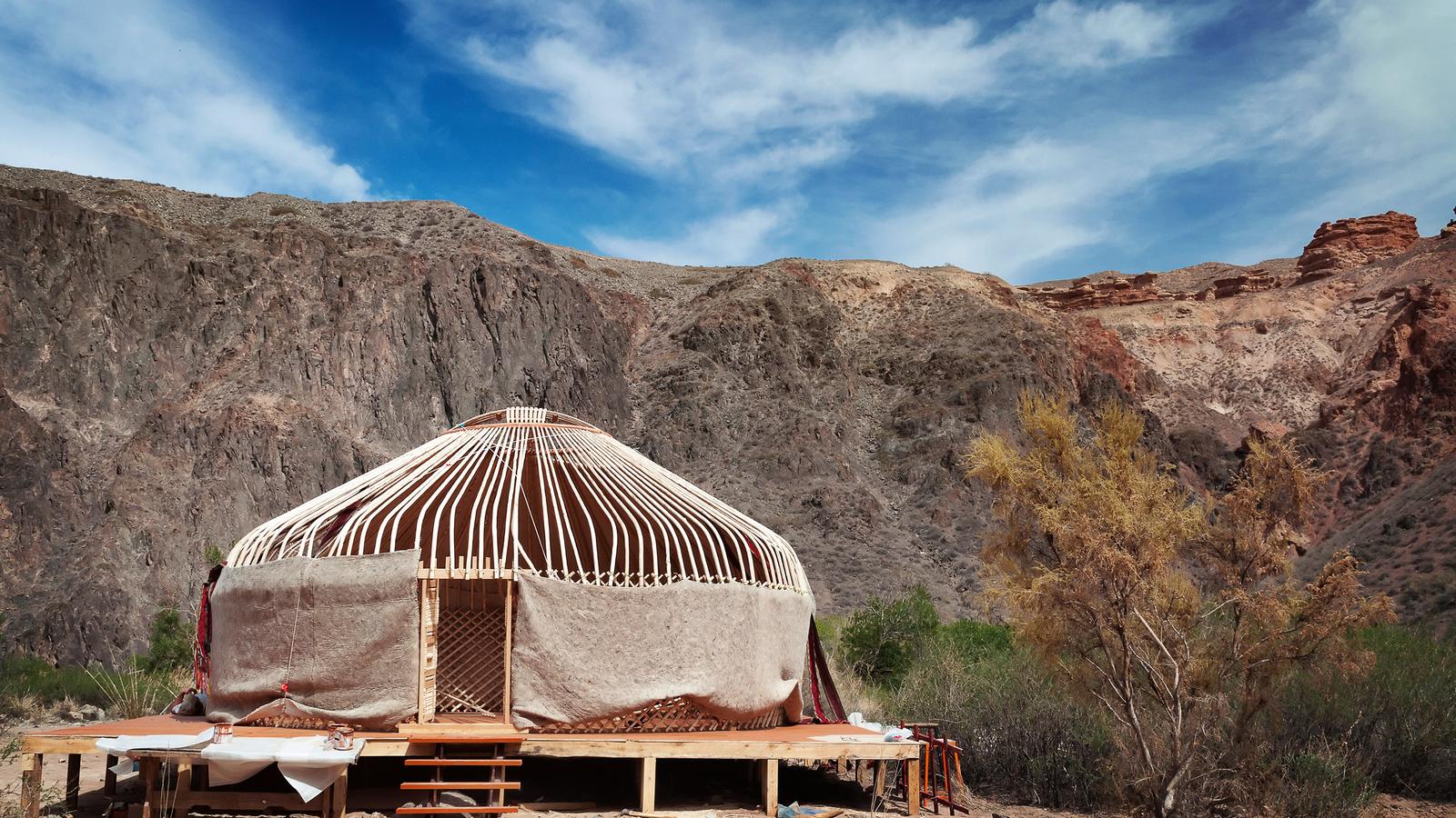 A yurt sits solidly on a sunny day in Kyrgyzstan