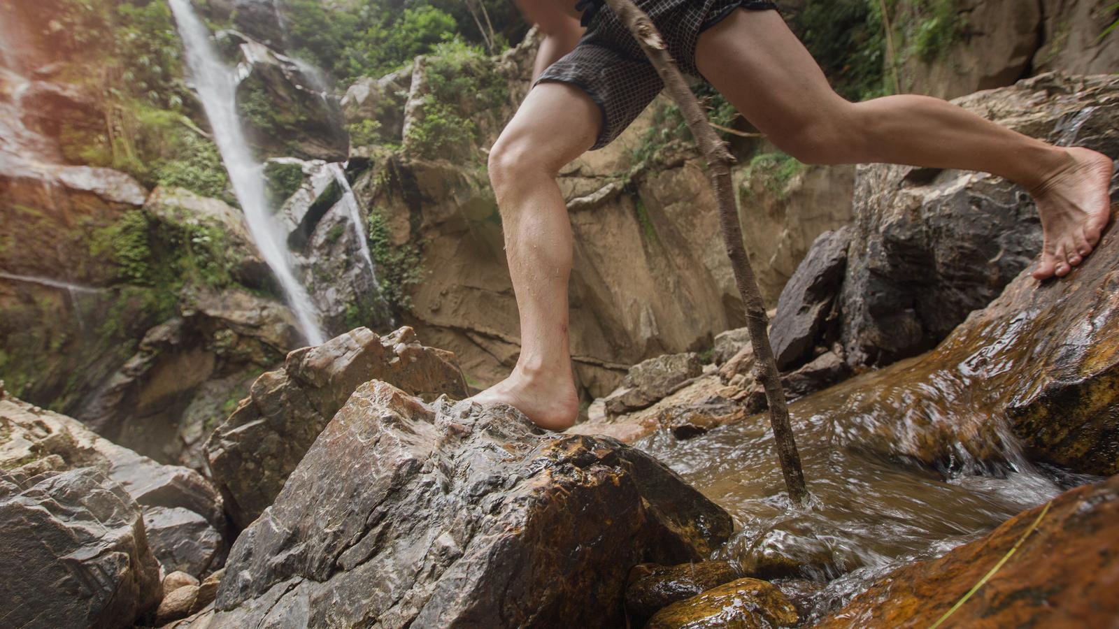 Hiking along the rocks of a waterfall in Chang Mai