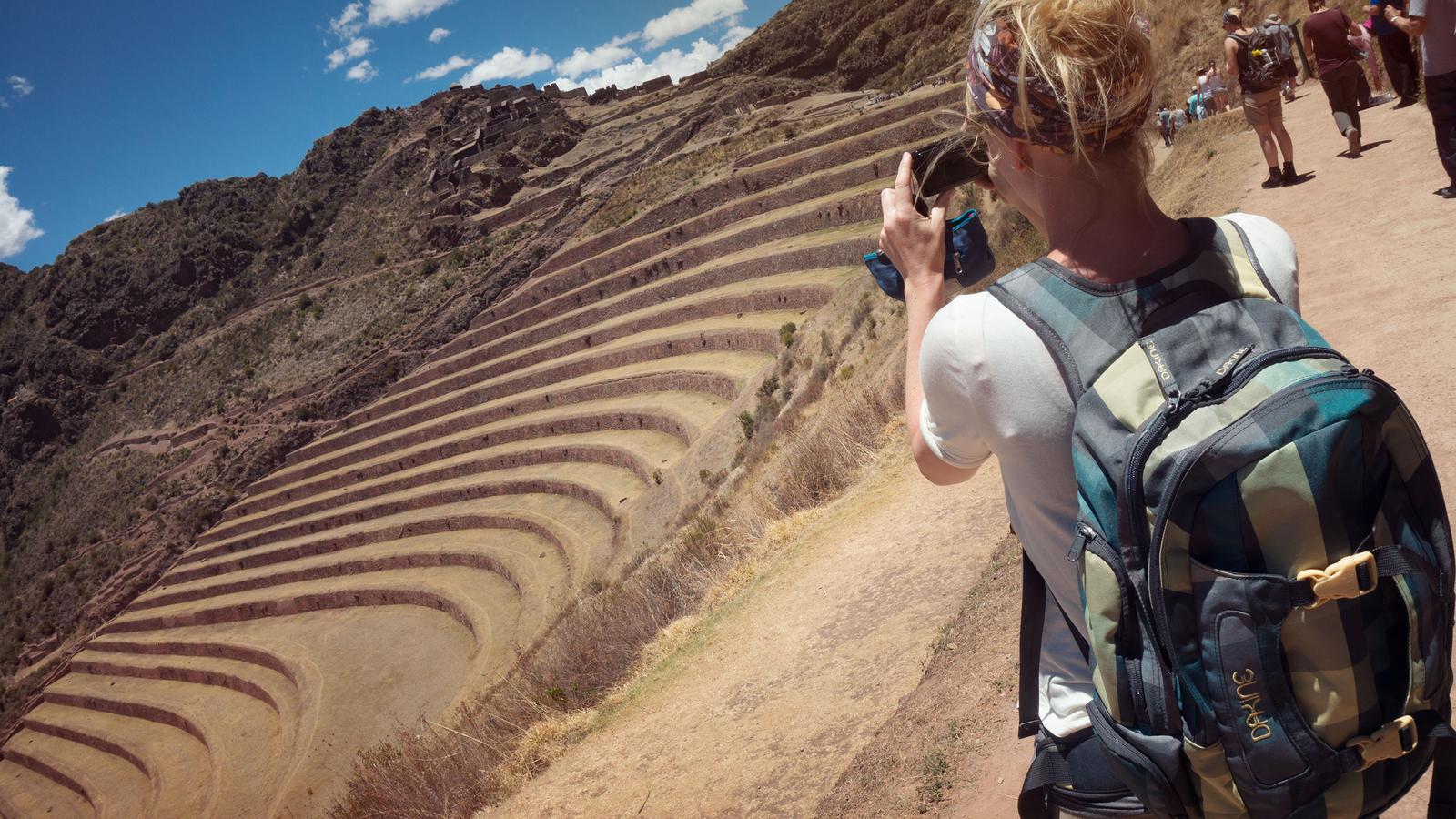 Traveller shooting photos of Inca ruins