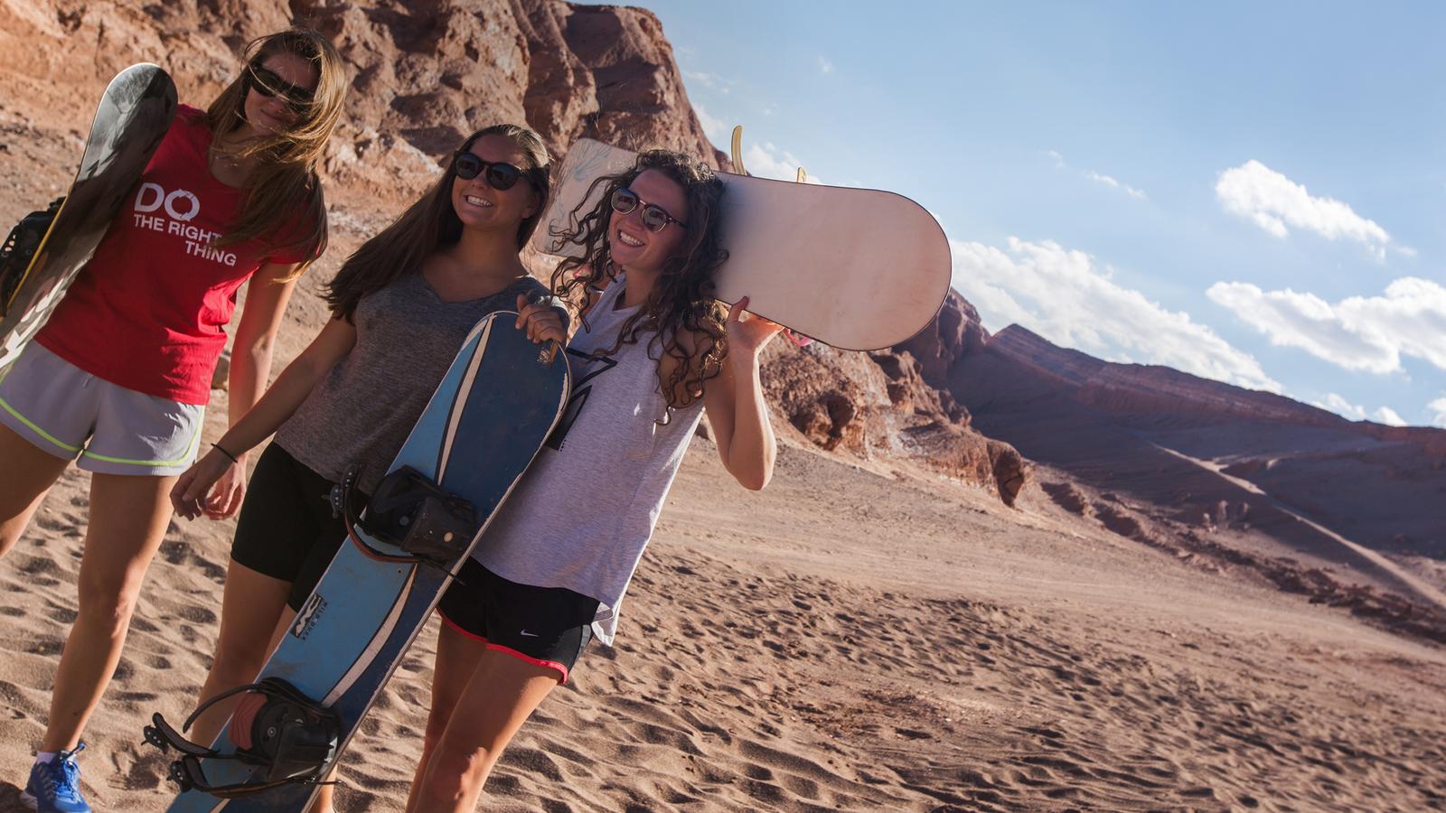 Travellers getting ready to sandboard in the Atacama dessert in Chile