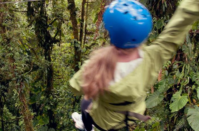 Female tourist ziplining in Costa Rica's Monteverde cloud forest reserve.