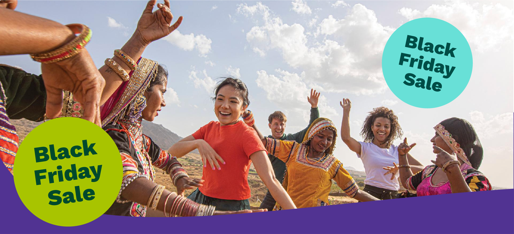 Two women sharing a cultural experience sitting together outdoors with crafts and traditional items