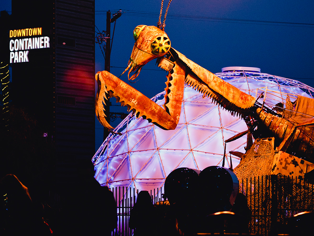 A giant, fire-breathing praying mantis sculpture overlooks Downtown Container Park in Las Vegas.