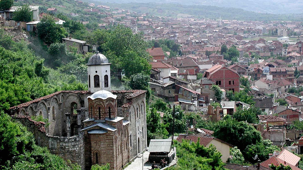 You'll find Prizren sunken in a tight river valley below mountains often lost in fog. Photo courtesy Wiki.