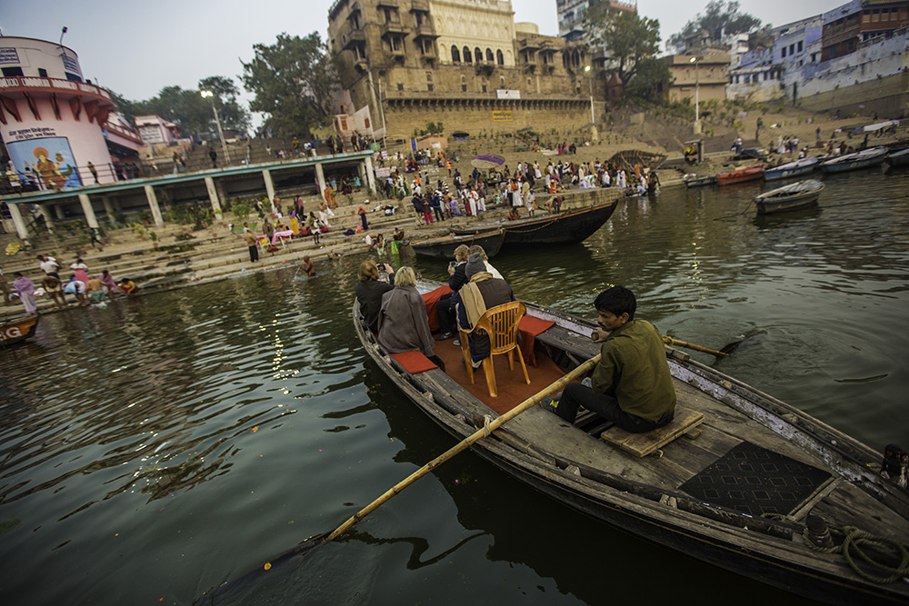 A boat glides down the sacred Ganges.