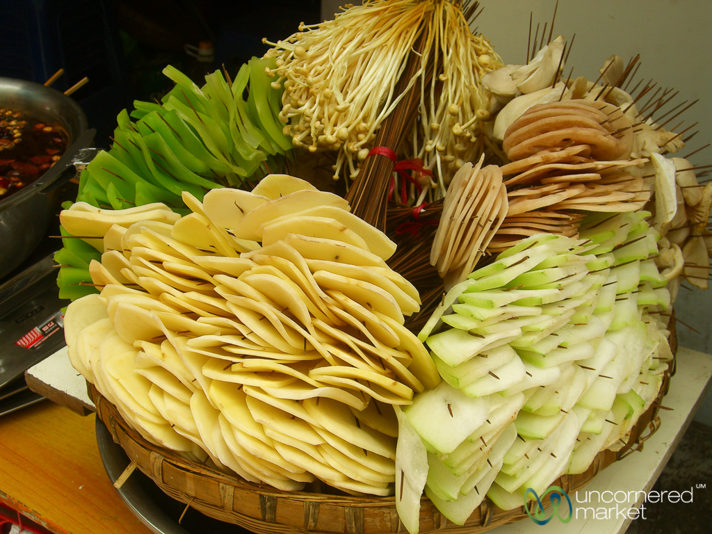 Hot pot ingredients on skewers at a street-side stall.