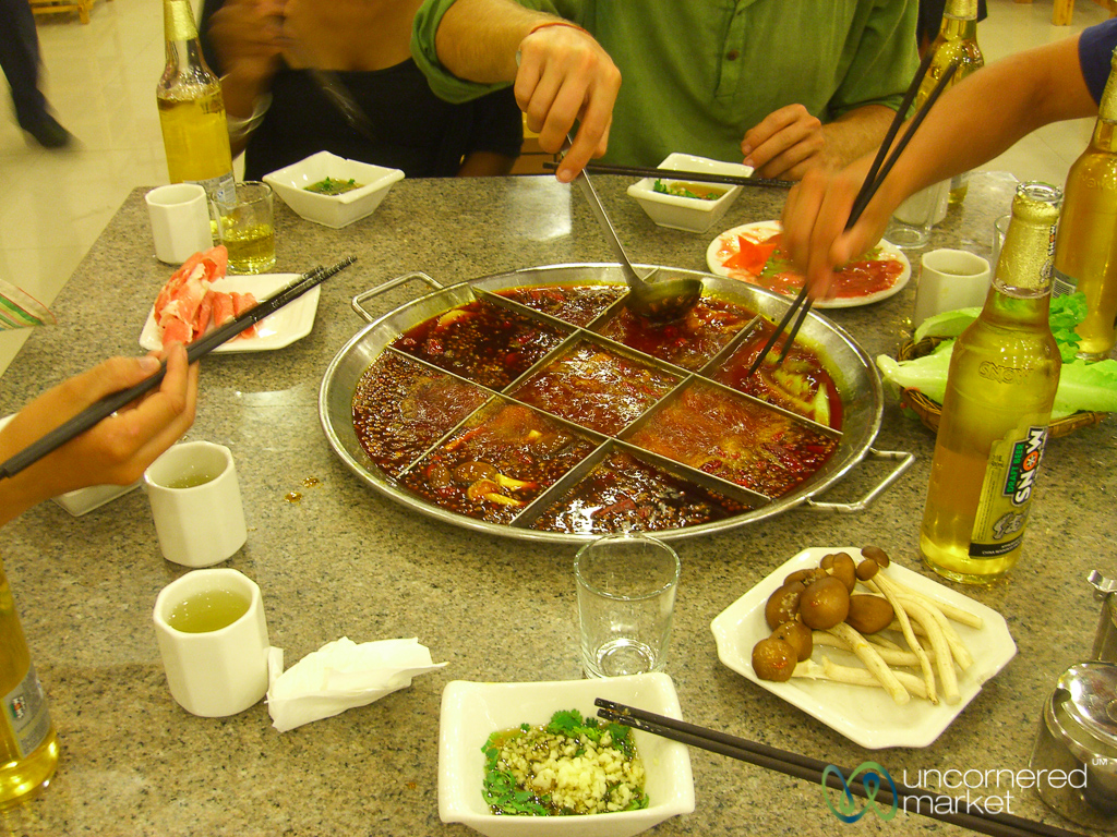 The fun of trying to extract our food from a fiery Sichuan hot pot.