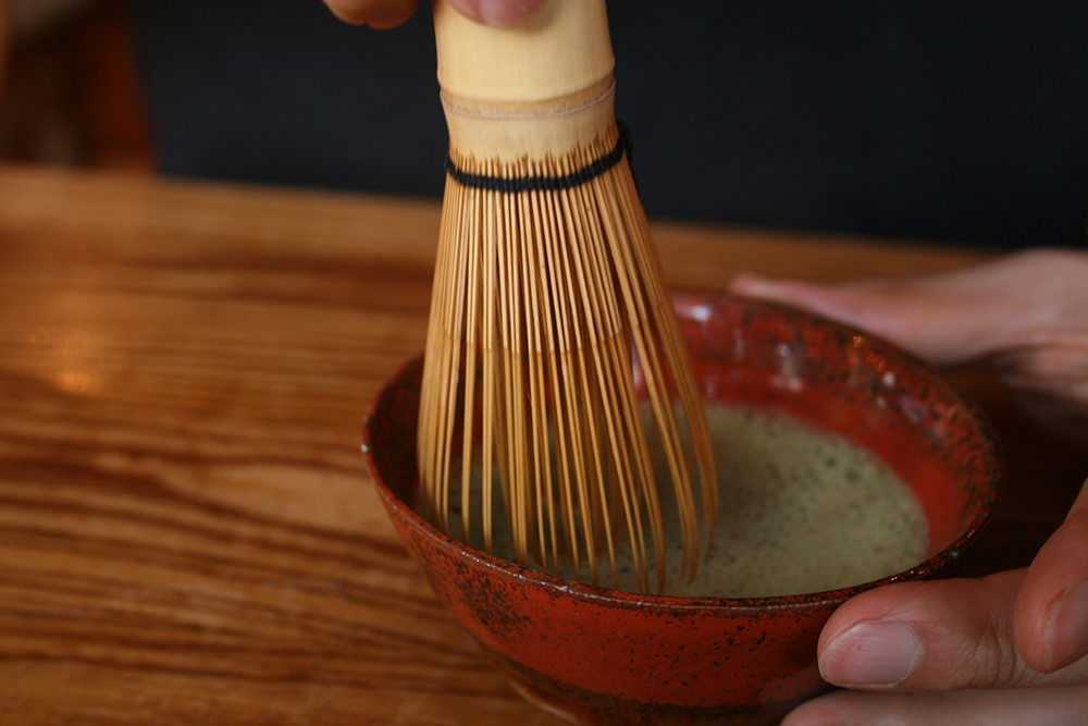 Matcha powder is whisked into hot water to create matcha tea. Photo courtesy of Akuppa John W.