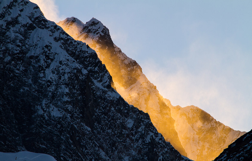 The morning sun catching its light in a spindrift off the side of this Himalayan peak.