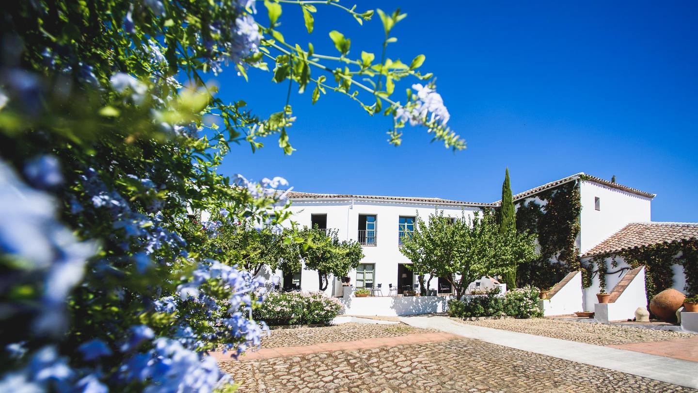 Hotel Molino del Arco Exterior. White building, blue sky.