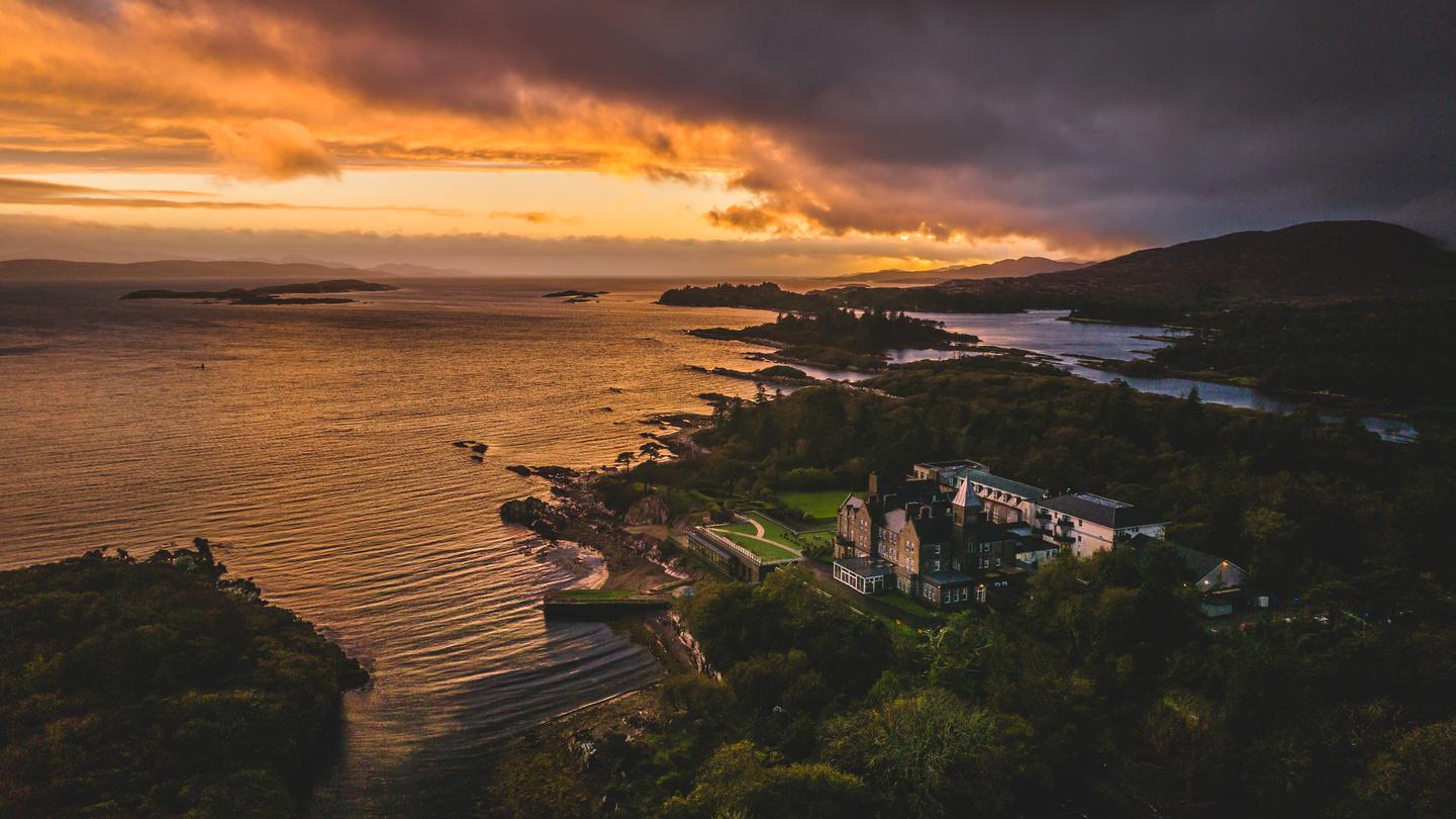 Night image of the property overlooking the water with a sunset